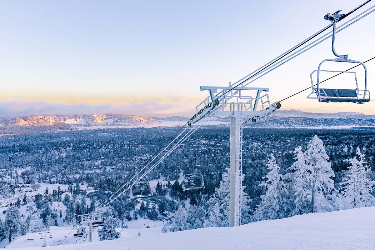 A chairlift over snowy pines on Bear Mountain above Big Bear Lake