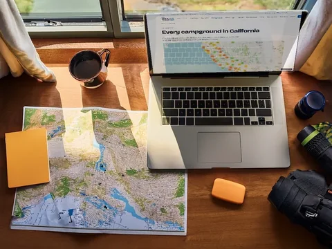 A laptop showing a map beside printed campground notes covered in handwriting